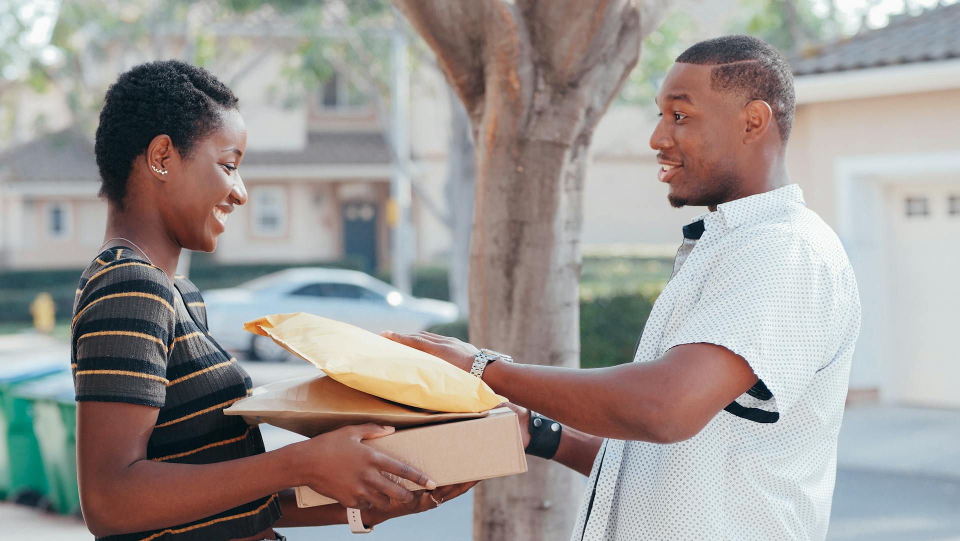 Man in White Button Up Shirt Delivering Parcels
