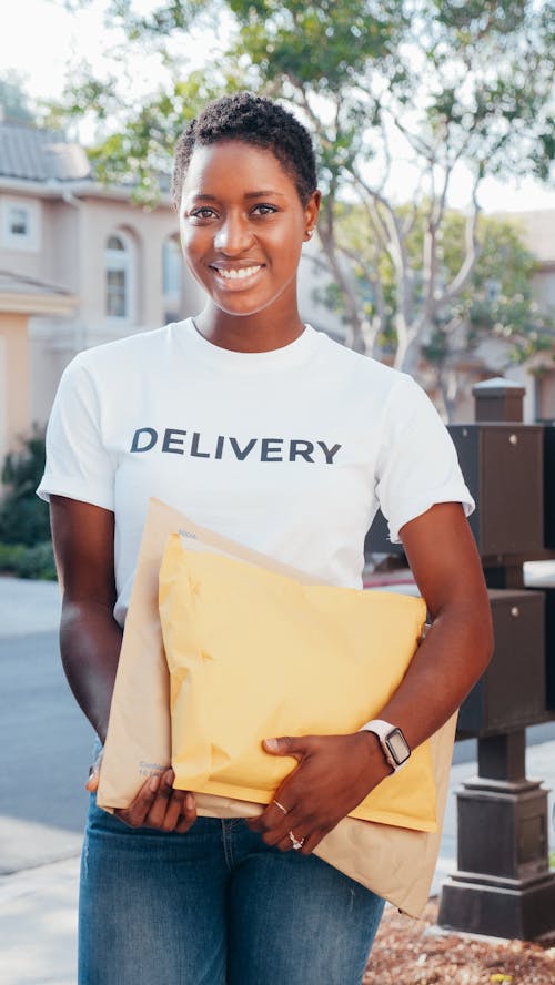 Smiling Woman in White Crew Neck T-shirt Holding Parcels to Deliver