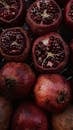 Delicious pomegranates heaped together on table