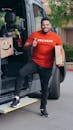 Man in Red Crew Neck T-shirt Making Deliveries