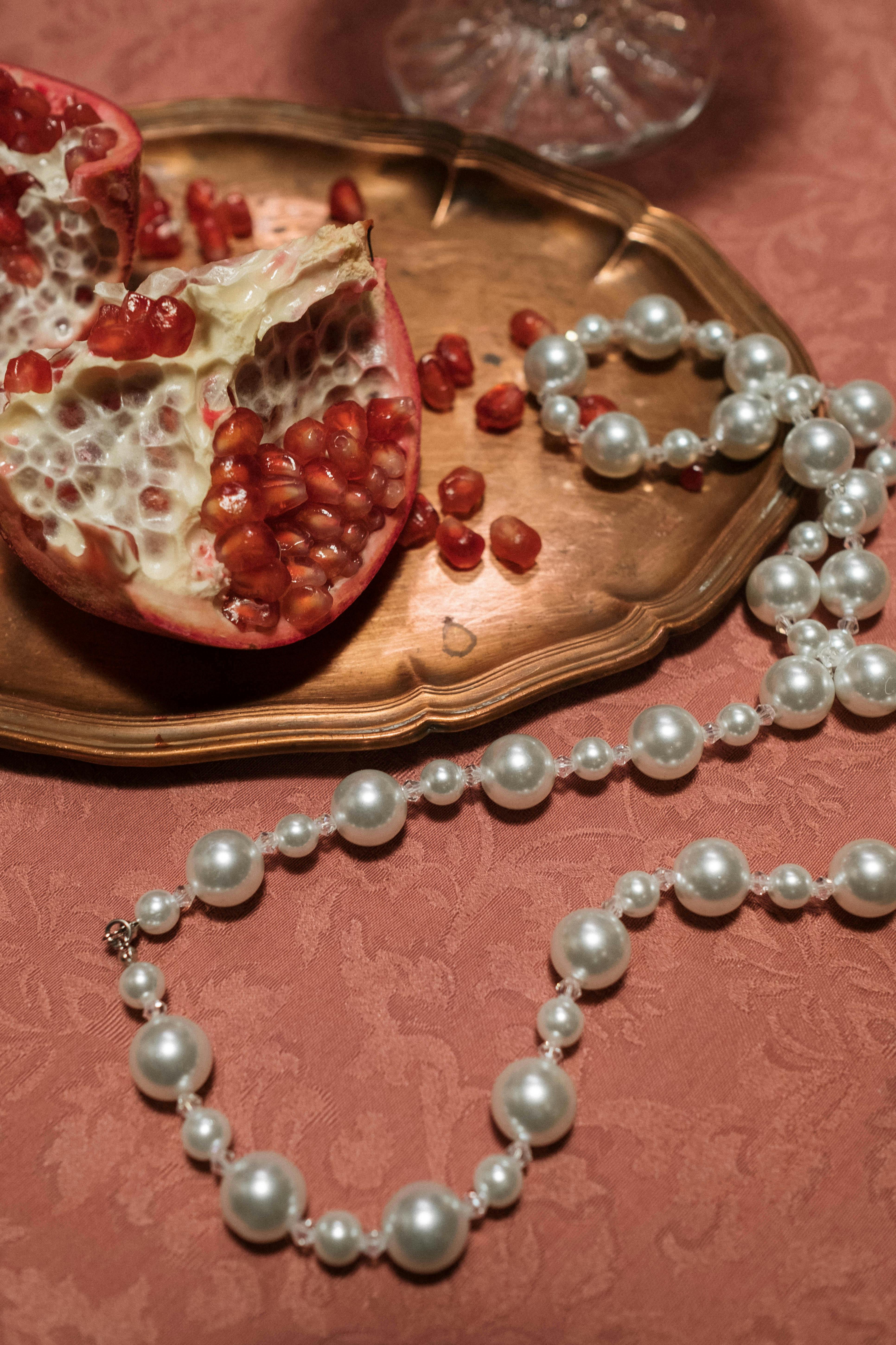 white pearl necklace on table