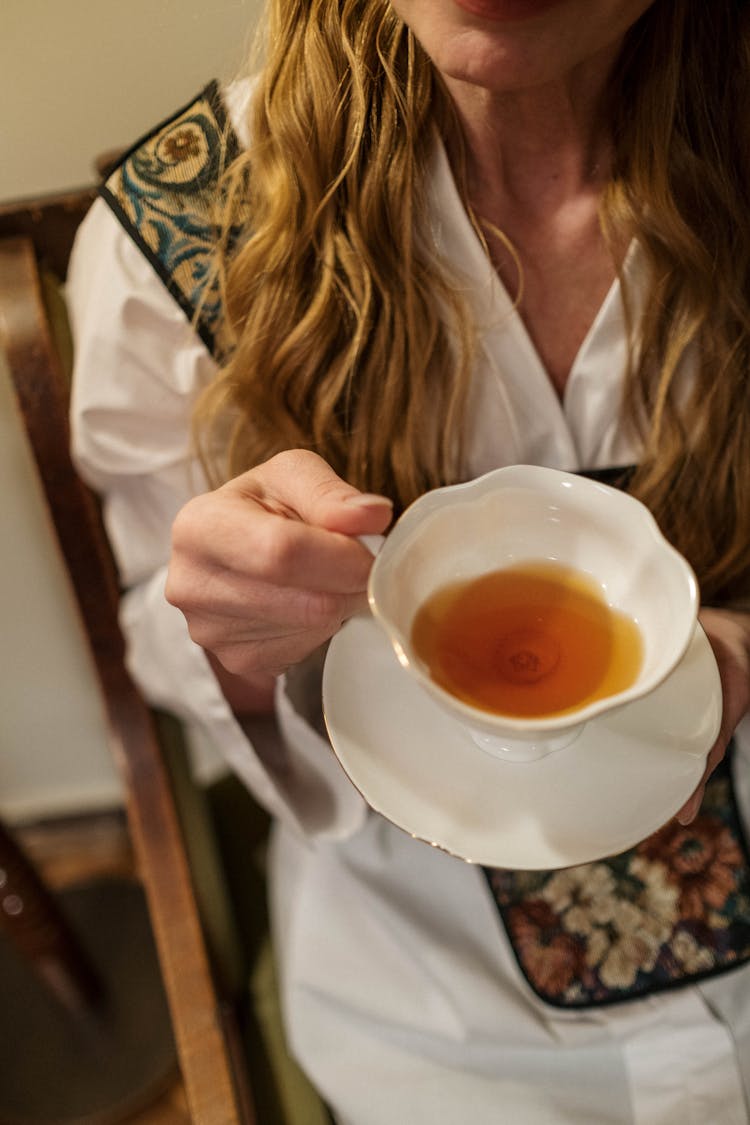 Woman In White Button Up Shirt Holding White Ceramic Teacup