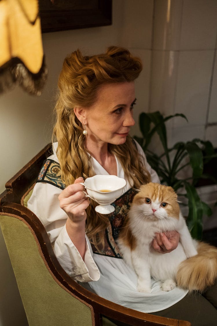 Woman Holding Her Orange And White Cat