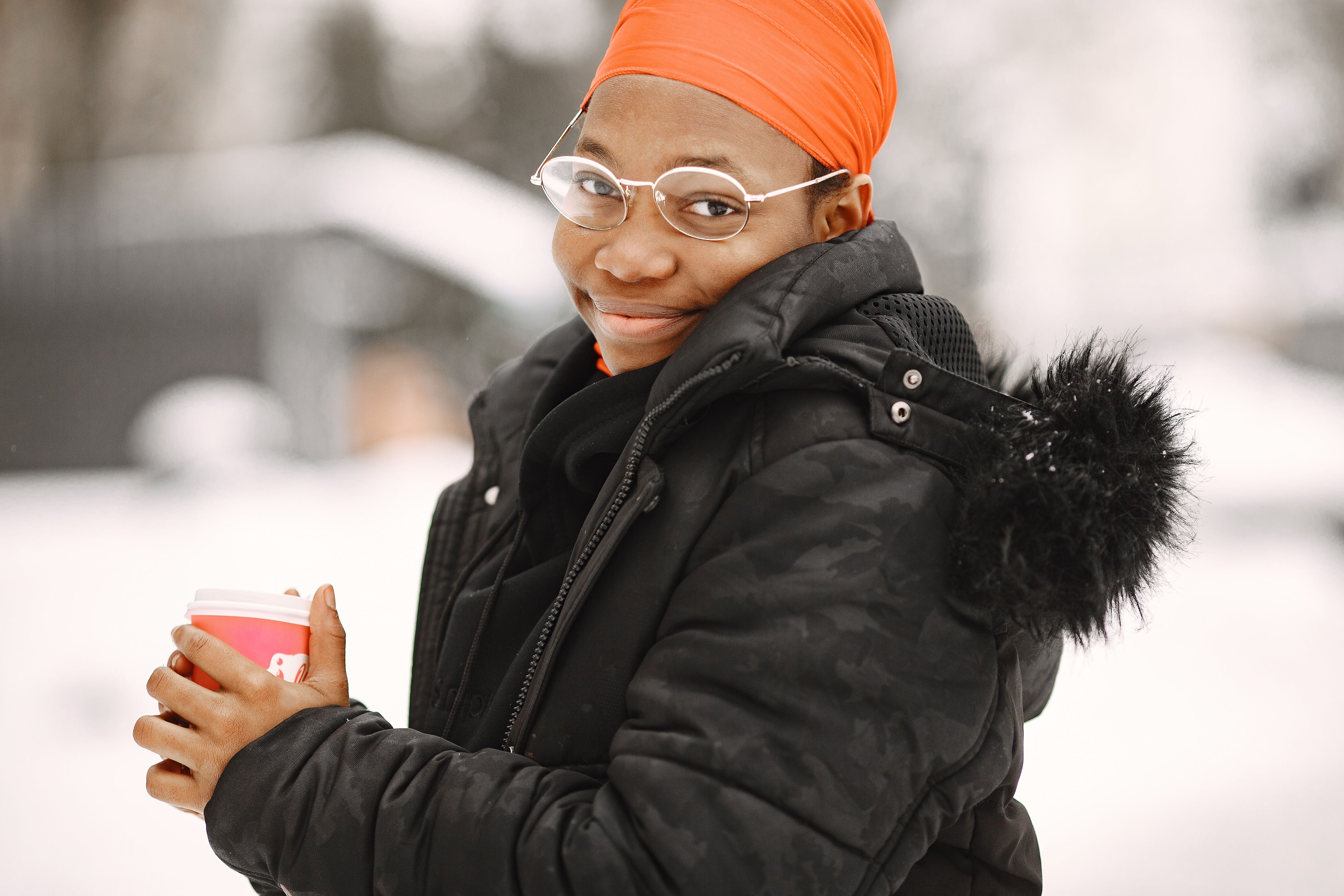 Close-up of a Woman Holding her Coffee While Smiling · Free Stock Photo