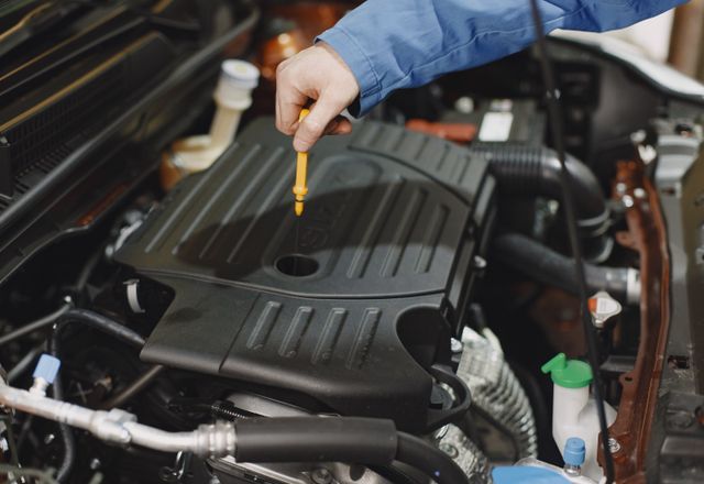 Checking engine oil level with a dipstick