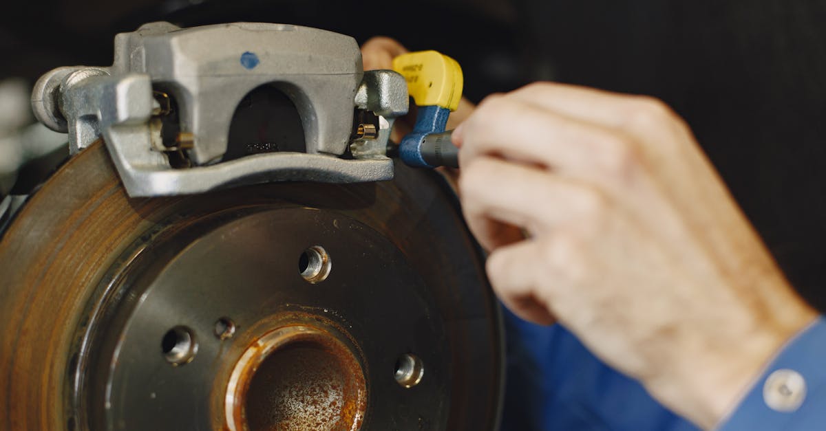Brake Pads Worn Down With Visible Damage And A Close-up Of A Mechanic Inspecting Brake Components In A Garage Setting