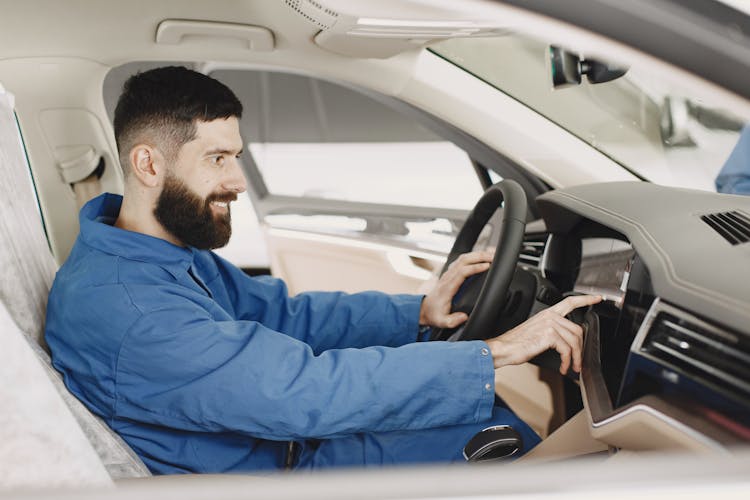 Mechanic Inside A Car Smiling