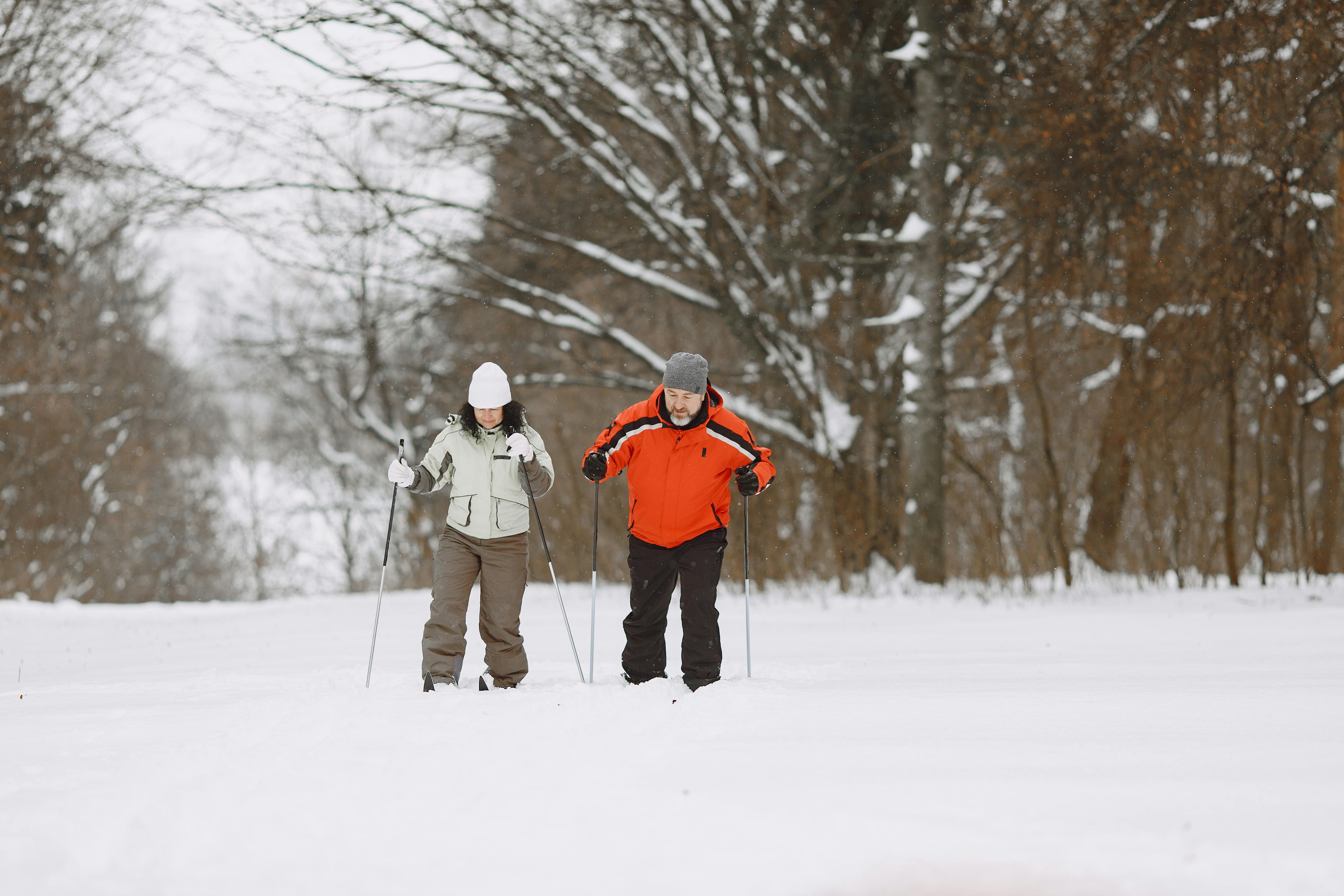 Prescription Goggle Inserts - Two adults cross-country skiing in a snowy winter landscape, wearing winter gear.