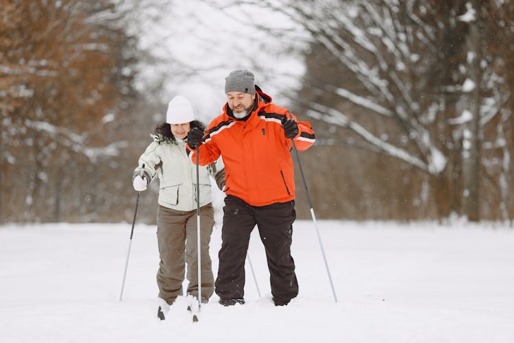 Man And Woman Holding Ski Poles