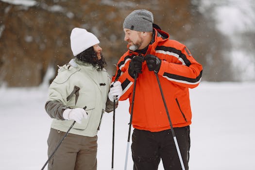 A joyful couple in winter attire skiing together, showcasing love and companionship in a snowy landscape.