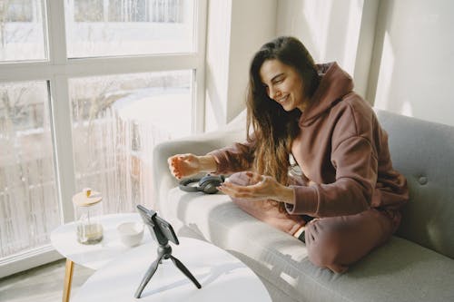 Free A Woman Recording Herself with Her Smartphone Stock Photo