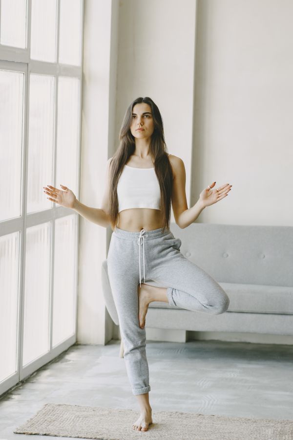 Woman practicing yoga at home