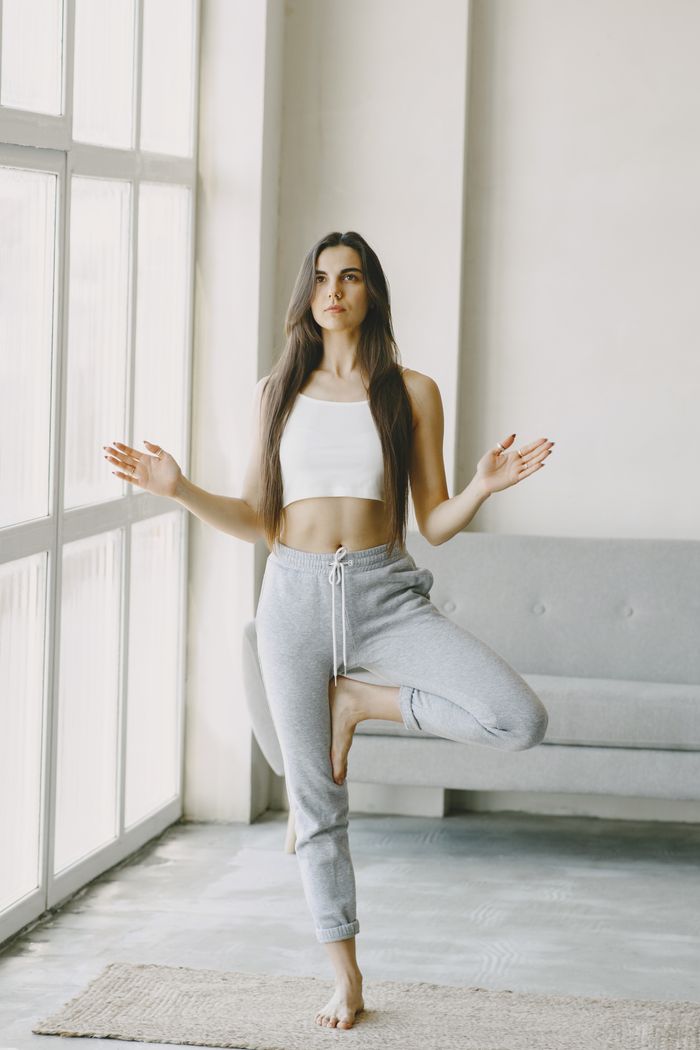 Woman in Vrikshasana, the tree pose