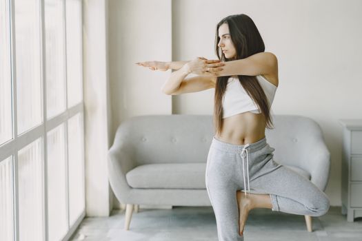 A Woman in a White Tank Top Stretching