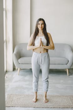 A young woman practicing yoga indoors in a peaceful and serene setting. Perfect for wellness and lifestyle concepts.