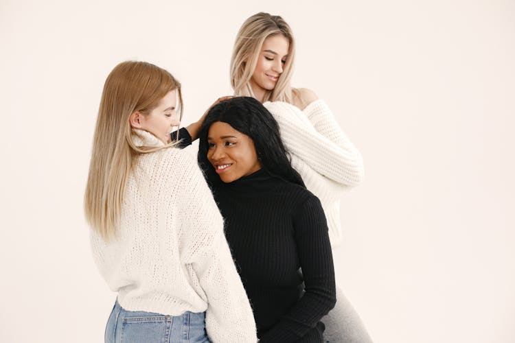 A Group Of Women In Knitted Sweaters