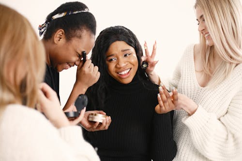 Free Photo of Women Putting Makeup on Their Friend Stock Photo