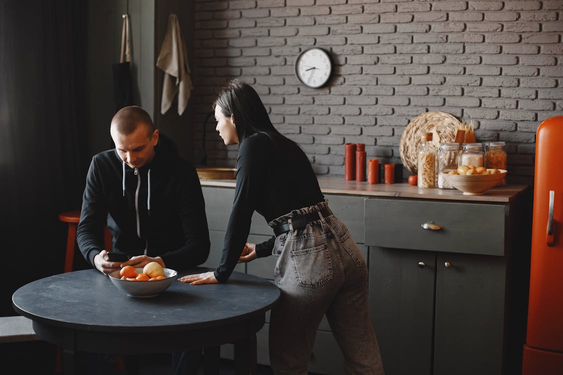 Free Man in Black Sweater Sitting Beside Woman in Gray Sweater Stock Photo