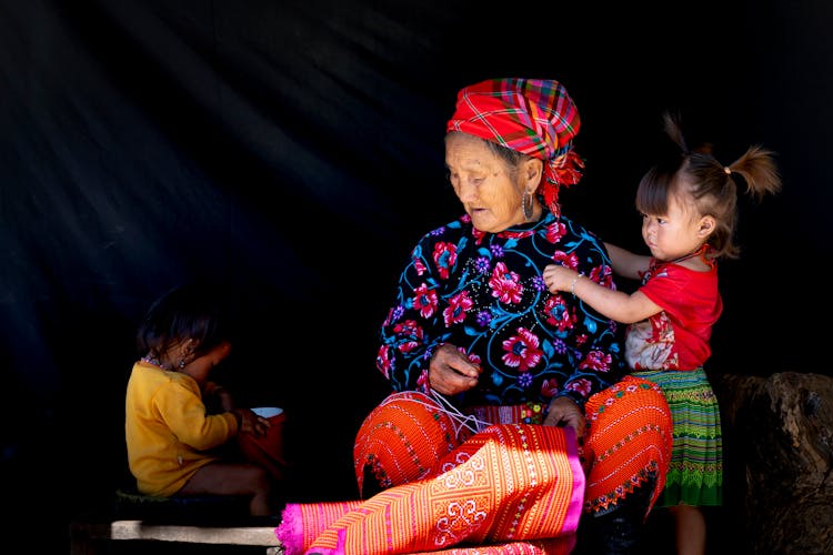 An Elderly Woman With Her Grandchildren