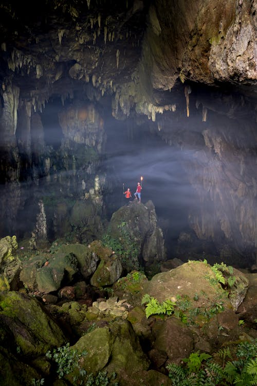 People Exploring Inside a Cave