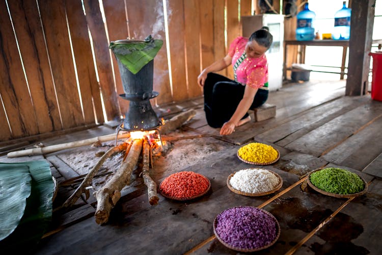 Woman Cooking Over A Fire