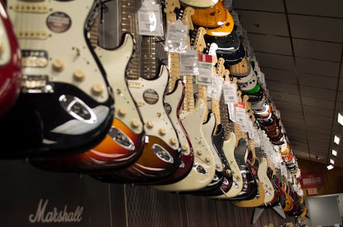 Free Electric Guitar Hanging Near Wall Stock Photo