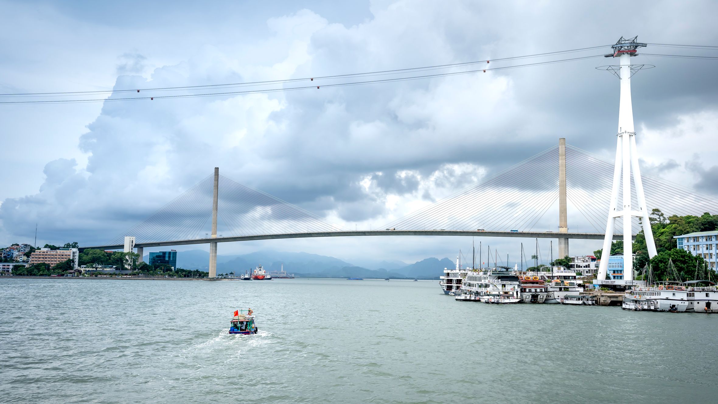 A breathtaking view of Bai Chay Bridge with a picturesque cloudy sky in Vietnam.