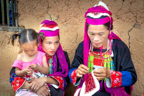 Free Three generations engaging in traditional sewing, showcasing cultural heritage. Stock Photo