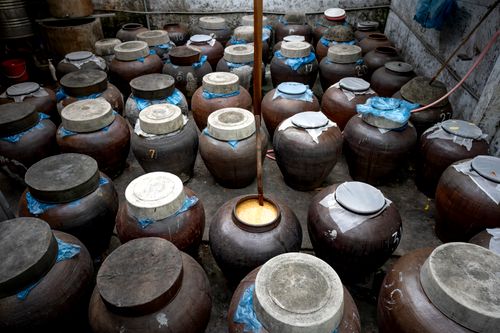 Free A collection of rustic ceramic jars in a traditional storage setting, showcasing cultural heritage. Stock Photo