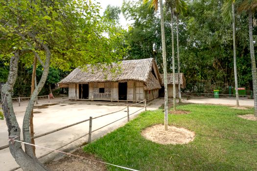 Charming straw huts surrounded by vibrant greenery, perfect for summer retreats.
