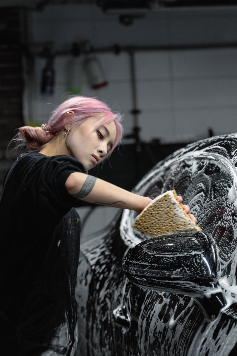 Detailer polishing a vehicle's painted surface