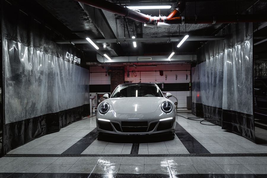 Luxury vehicle inside a professional car wash bay