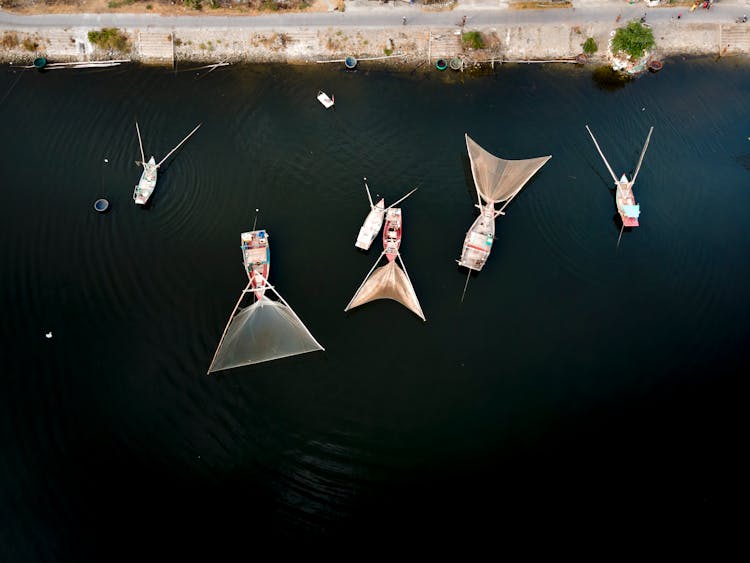 Boats With Fishing Nets In Water