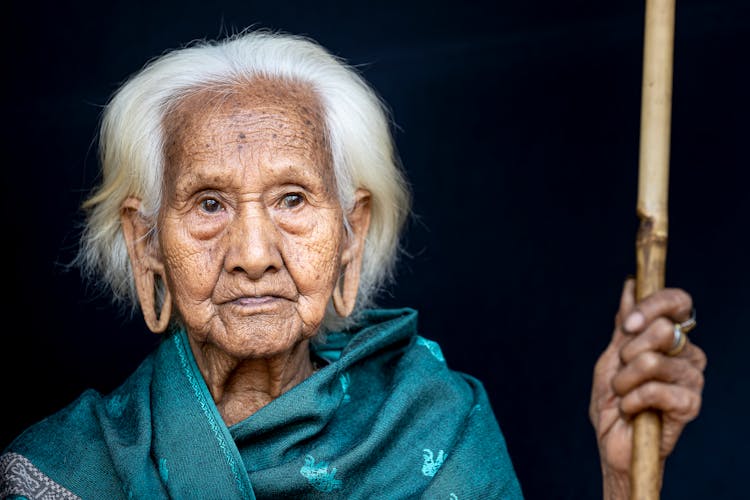 Old Tribal Woman On Black Background