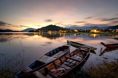 Boats Docked by Lake Shore at Night