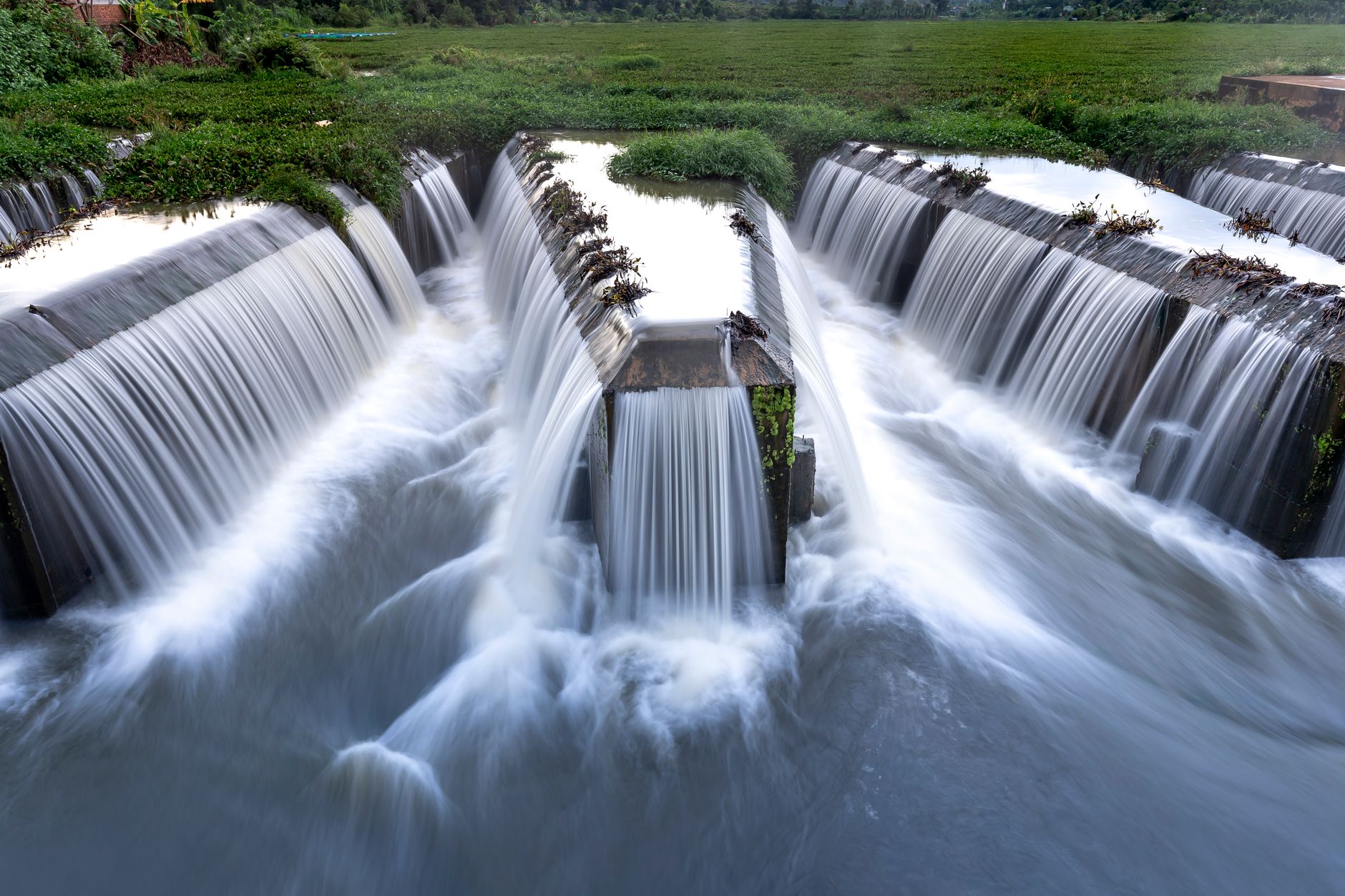 A tranquil scene of waterfalls cascading in a green landscape, creating a serene and natural atmosphere.