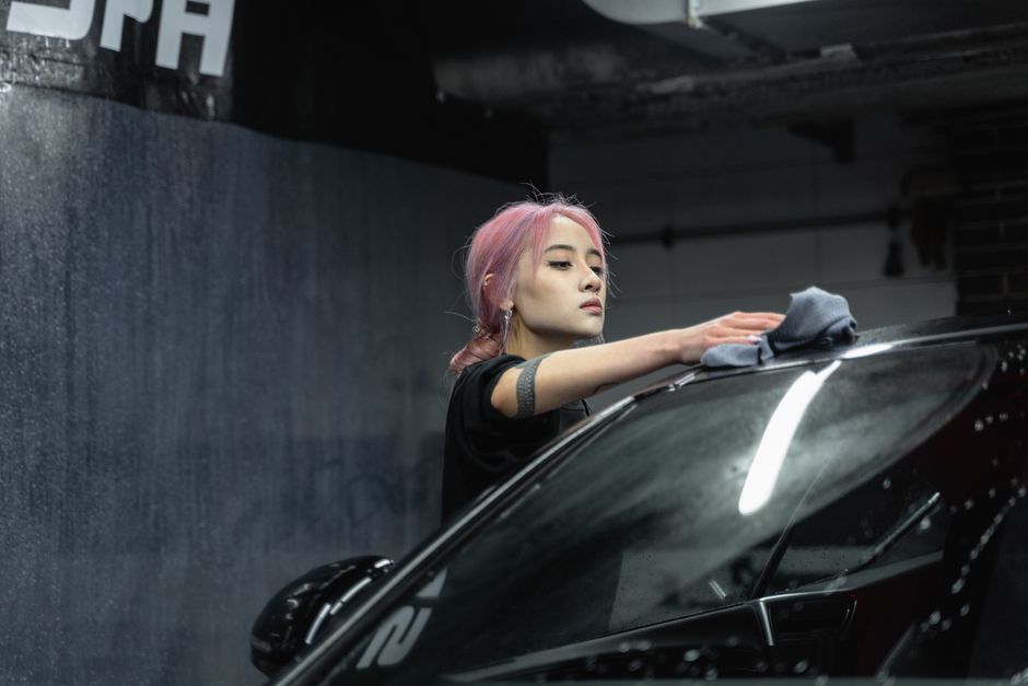 Person using microfiber cloth to remove tree sap from car paint — step-by-step sap removal in Surrey BC