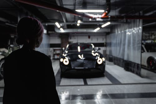 A Woman Looking at the Black Car