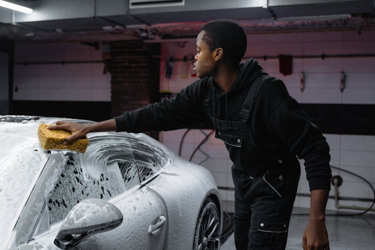 A Man Washing A Car