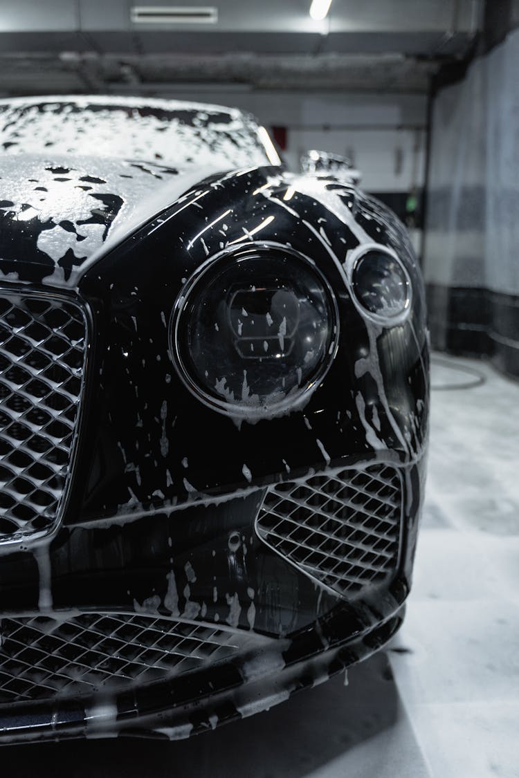 Soap Bubbles On A Black Car