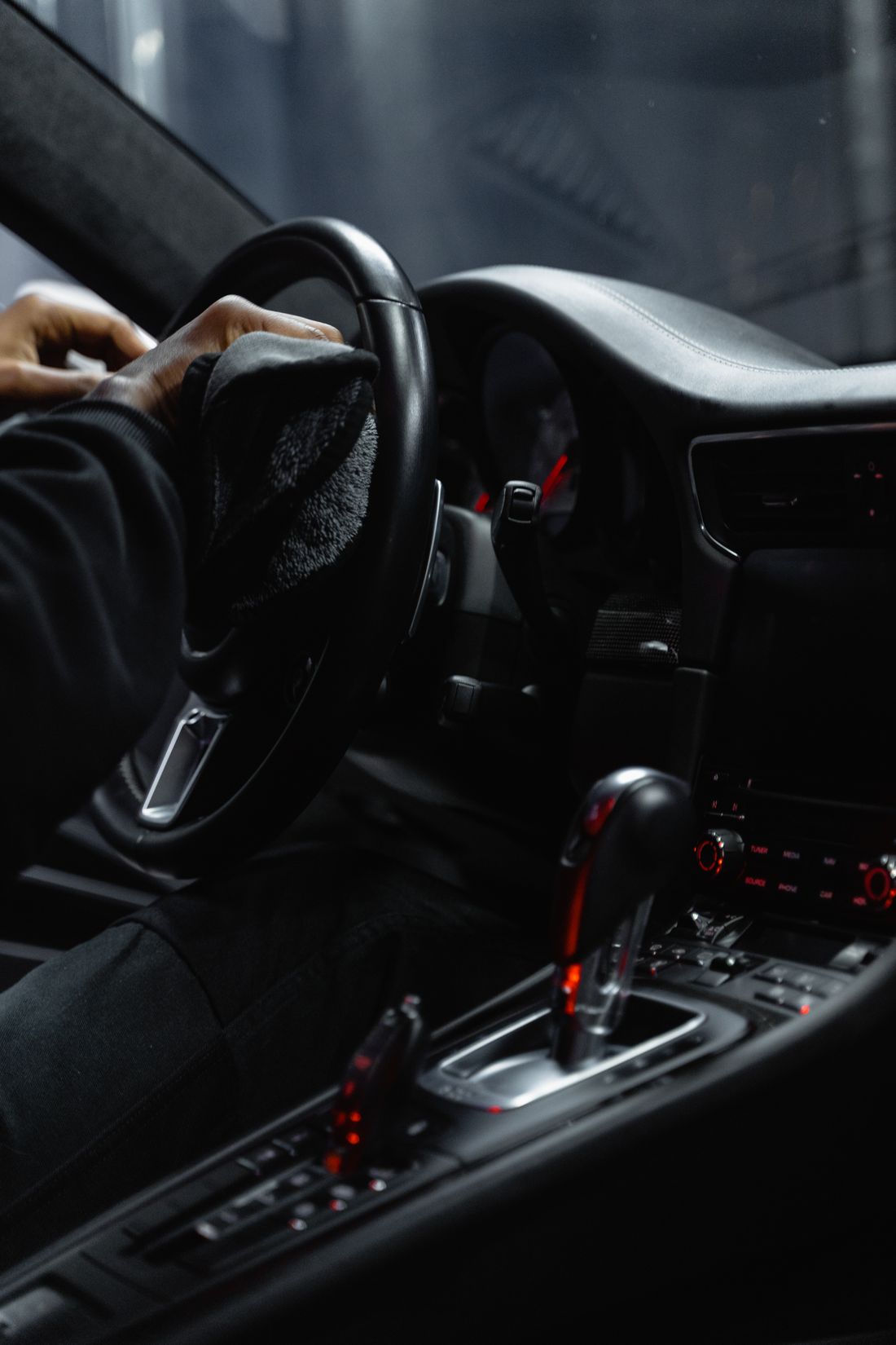 Luxury car interior being cleaned with microfiber