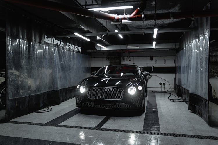 A Black Car Parked In The Carwash Garage