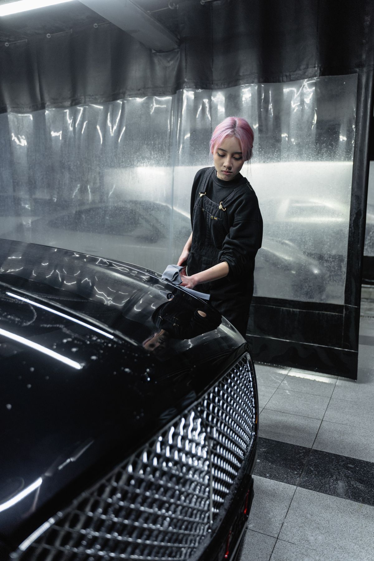Detailer cleaning a black car