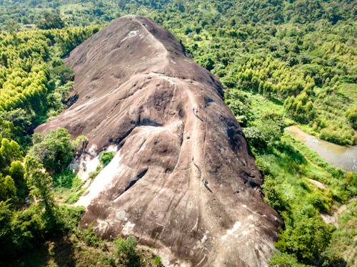 Free Giant Rock Formation Surrounded by Green Trees Stock Photo