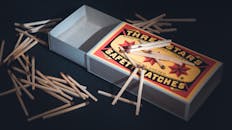 Matchsticks Beside a Matchbox on a Black Surface