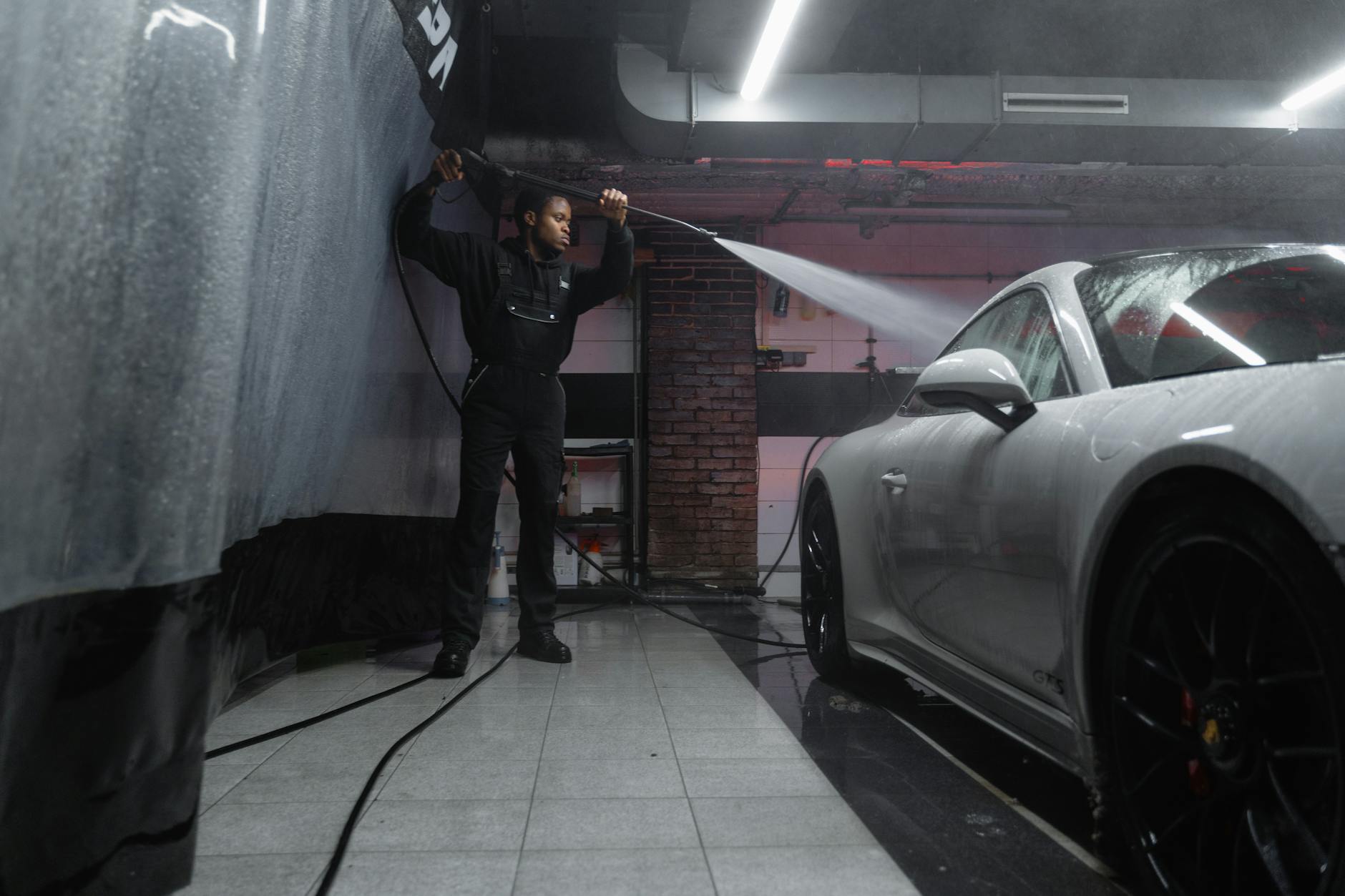 A Man Washing a White Car