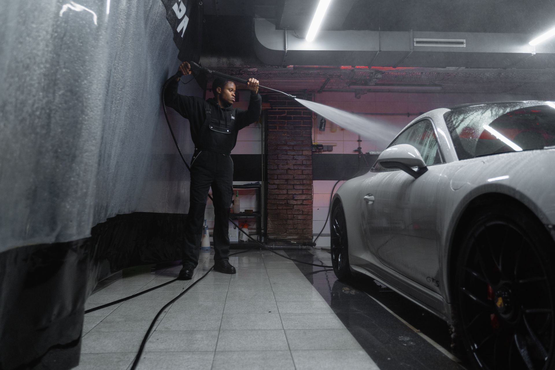 A Man Washing a White Car