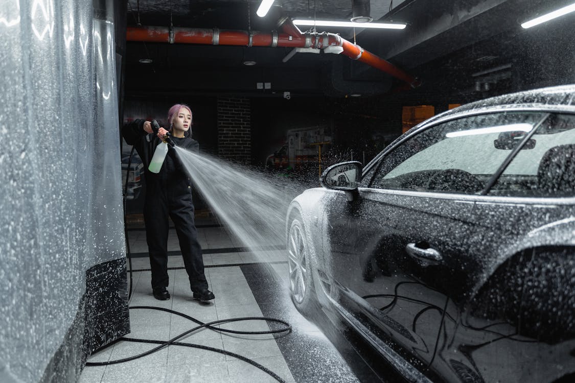 Free Photo of a Woman Washing a Black Car Stock Photo