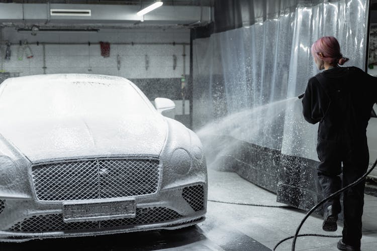 A Woman Cleaning A Car 