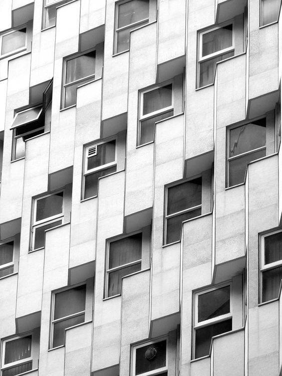 Facade of creative multistory building with geometric windows · Free ...
